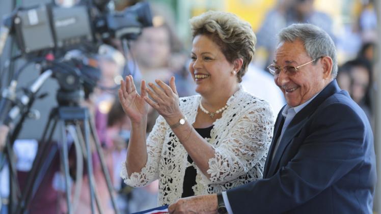 Cuba's President Raul Castro and Brazil's President Dilma Rousseff smile during the inauguration of a port in Mariel on the outskirts of Havana